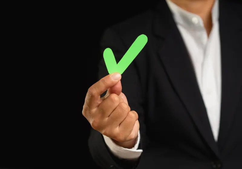 Man holding a green checkmark